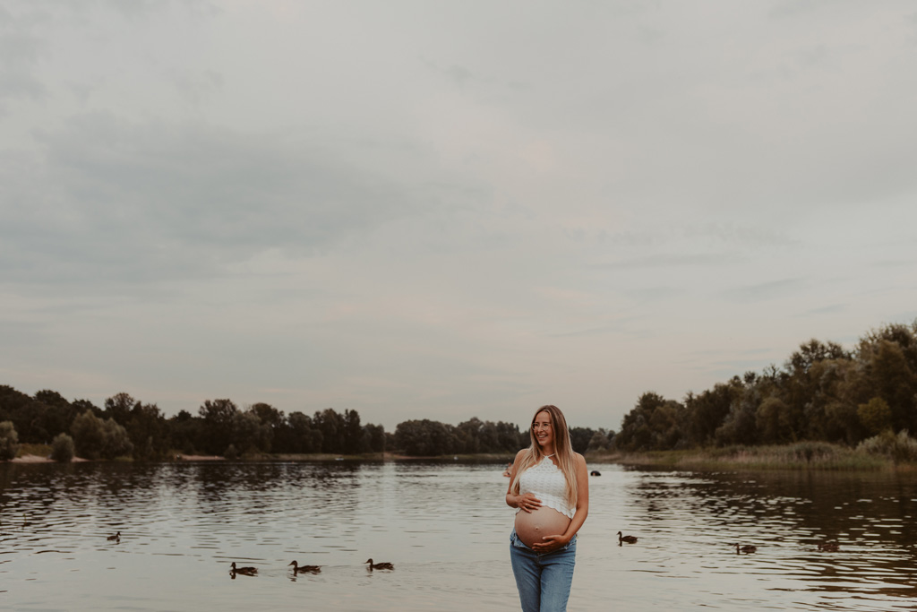 Babybauchfotos in Kaulsdorf in berlin am See und wir waren wieder im grünen in der Natur und haben ganz tolle fotos gemacht am Wasser und am Strand, sowie auf der wiese. es ist ein Paar und die beiden haben ihr erstes Kind erwartet. wir haben ein babybauchshooting gemacht. die sonne ging unter und ich habe fotos von den beiden gamacht. in Bewegung.